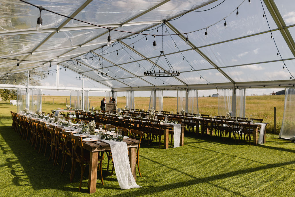 A clear tent set up for a wedding reception at the Gathered outside Calgary, Alberta. 