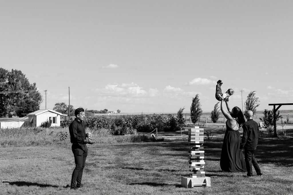 A black and white photo of a group of people playing a game in a field.