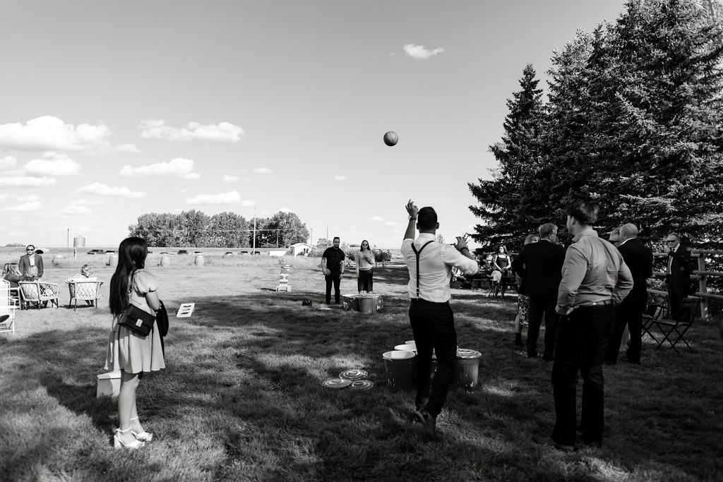 A black and white photo of people playing a game of frisbee.