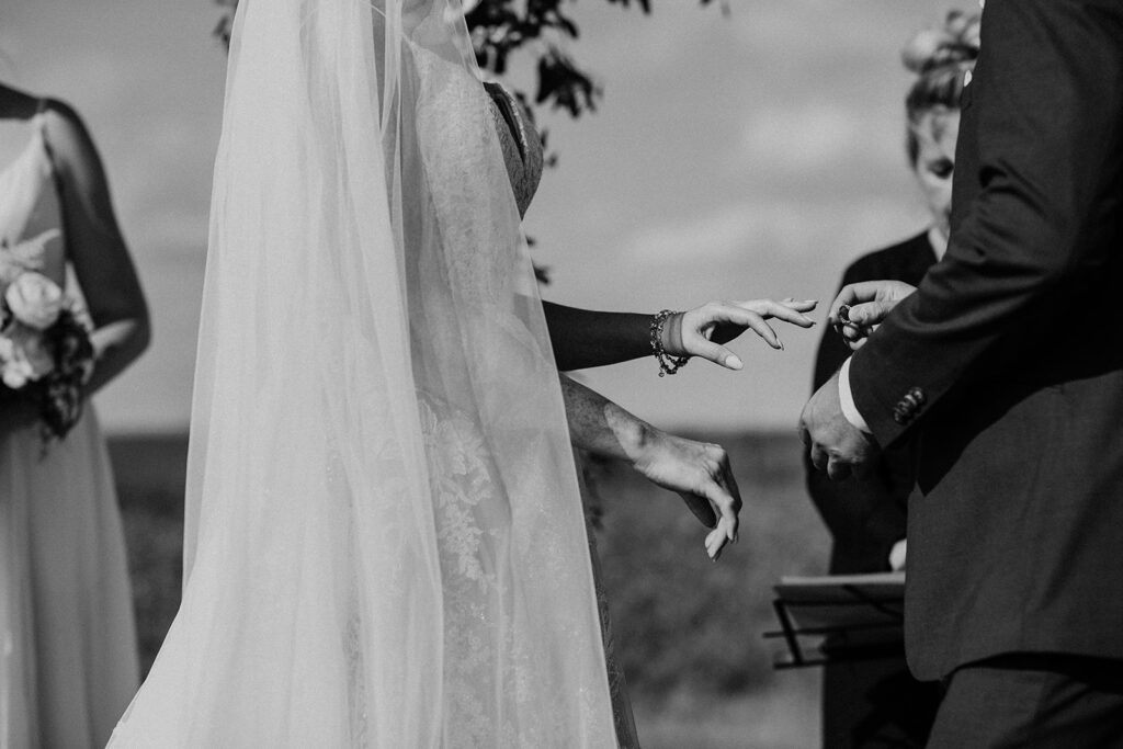 A bride and groom exchange rings during a wedding ceremony.