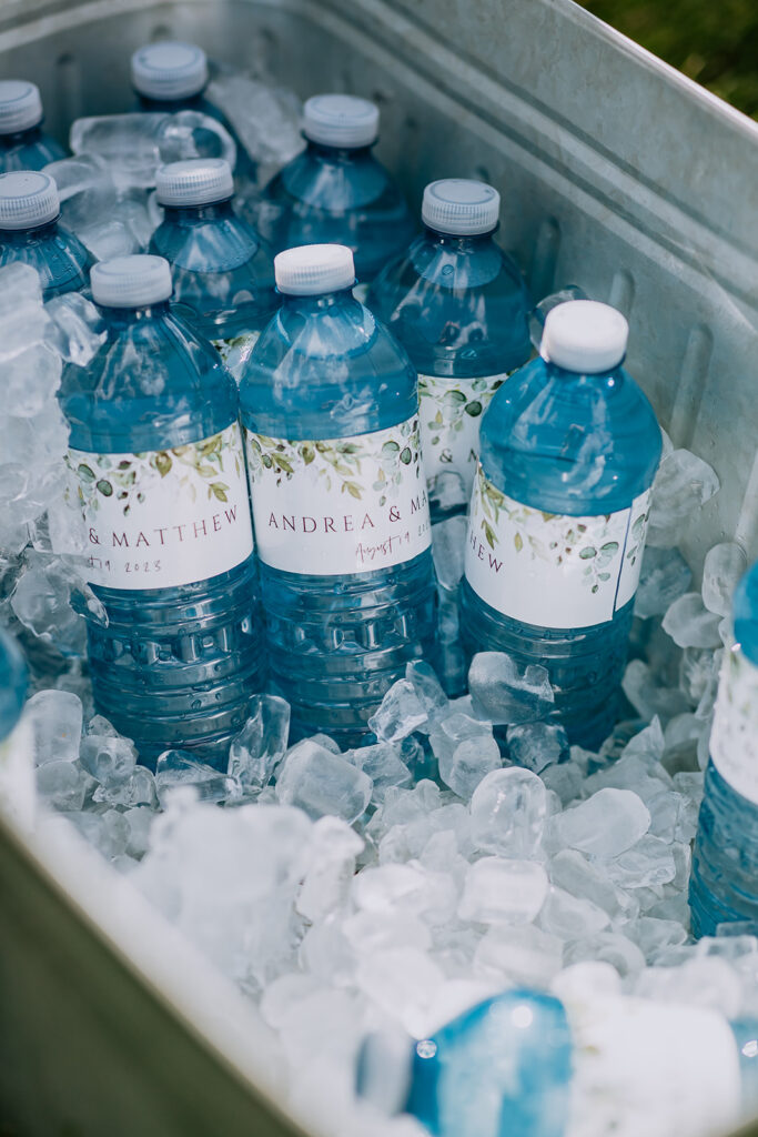 Custom-labeled water bottles cooling in a bed of ice.
