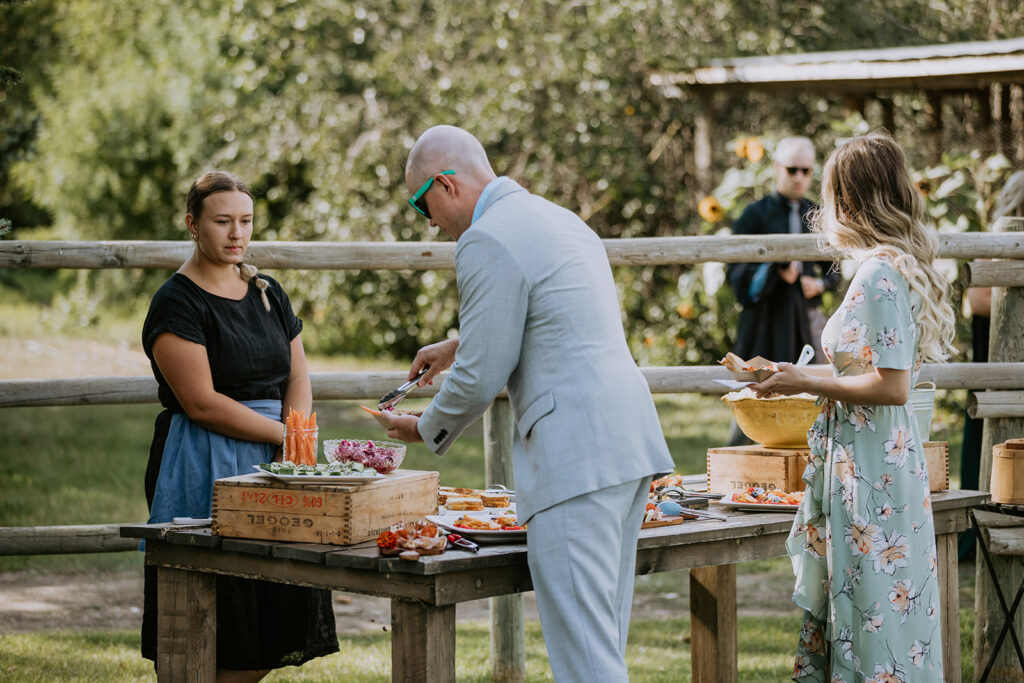 Guests serving themselves snacks at an outdoor event.