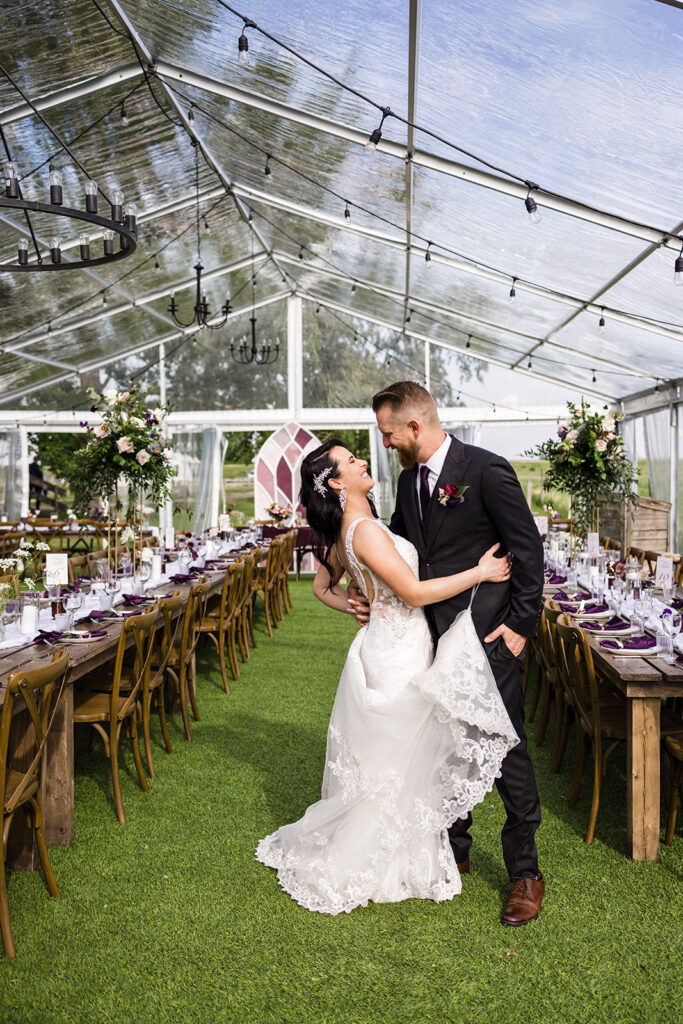 Bride and groom sharing an intimate moment in a beautifully decorated greenhouse wedding venue. A Garden Wedding with Pops of Plum