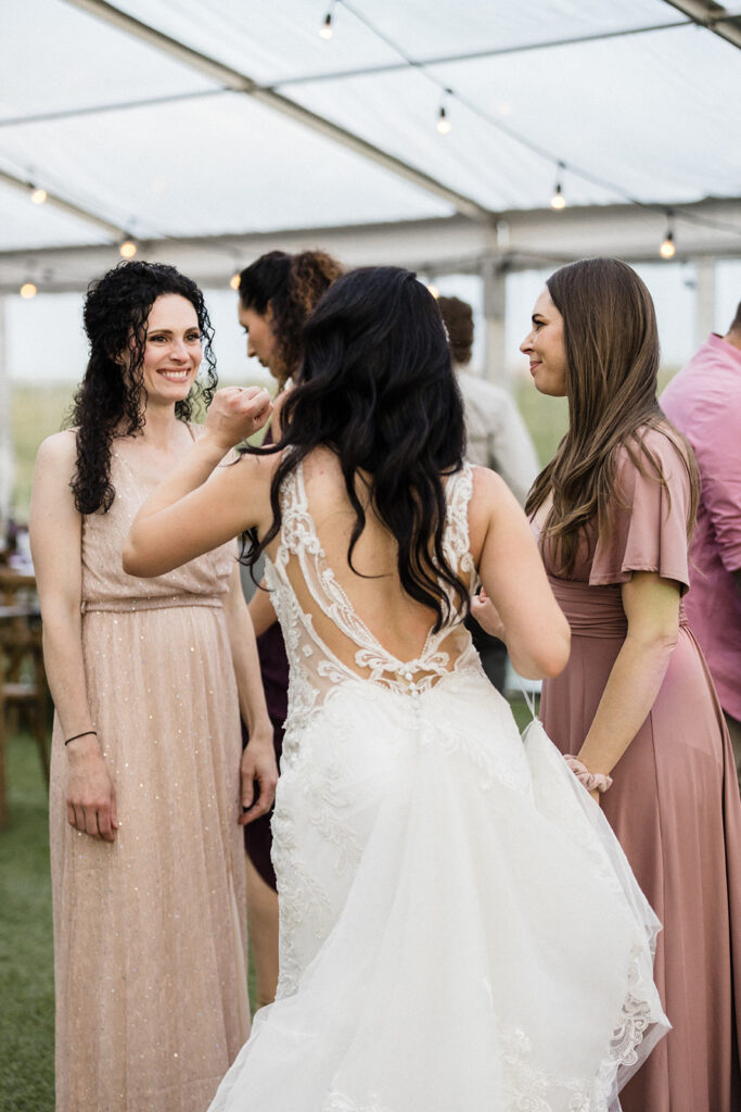 Bride conversing with guests at a wedding reception.